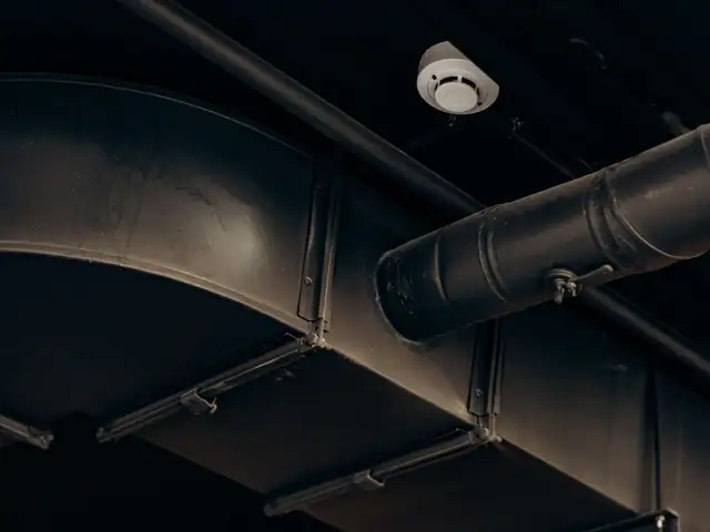 Exposed metal air ducts running along a ceiling